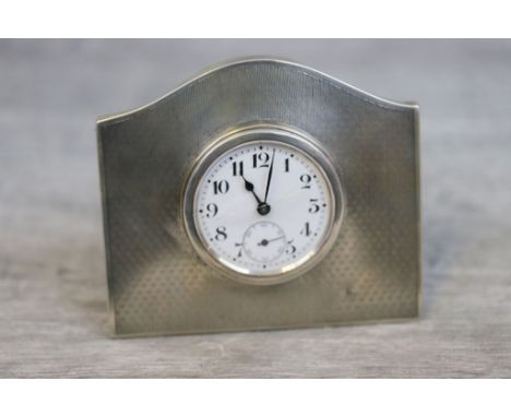 Silver Art Deco dressing table clock, white enamel dial and subsidiary dial, black Arabic numerals and poker hands, the mount