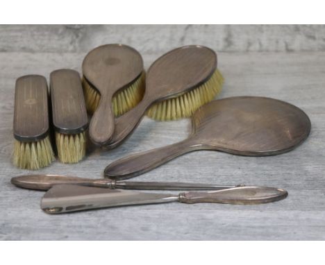 Silver backed dressing table brush set comprising two hand brushes, a hand mirror, two clothes brushes, a shoe horn and butto