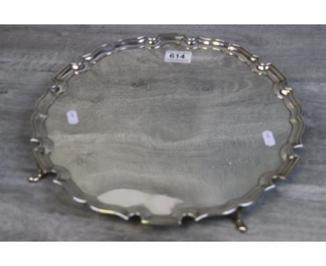 Large George V silver salver raised on four feet, plain polished form with Chippendale border, makers Fenton Brothers Ltd, Lo