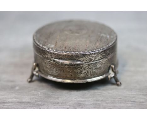 Early 20th century silver round jewellery casket raised on three fleur-de-lis feet, engine turned decoration to hinged lid, b