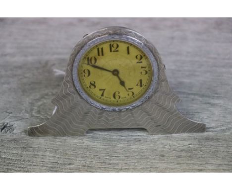 Art Deco silver mounted dressing table clock with easel back, the white metal clock with gilt engine turned dial with black A