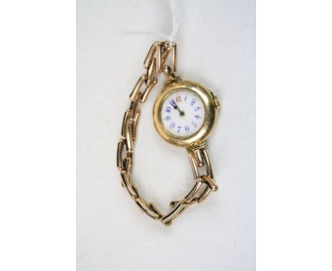 Early 20th century 18ct yellow gold cased ladies wristwatch, white enamel dial with blue and red Arabic numerals, 18ct gold d