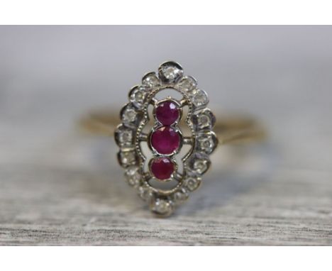 Art Deco style ruby and diamond 9ct gold ring, three graduated small round mixed cut rubies to centre, rub over setting, halo