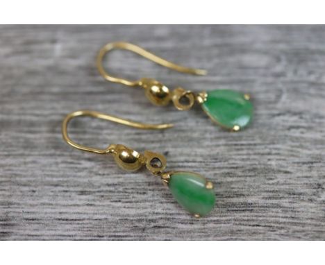 Pair of jade yellow metal drop earrings, comprising a pear shaped cabochon cut jade, dimensions approximately 9mm x 6mm, thre