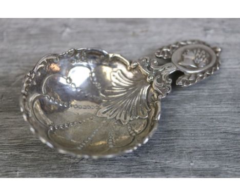 Edwardian silver caddy spoon, the bowl with cast foliate tongue and engraved scallop shell decoration with foliate scroll bor