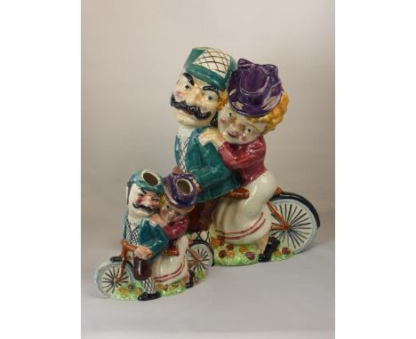 A William Shorter &amp; Son, 'Daisy Bell'  electric lamp-holder, with Daisy and her beau seated on a tandem. Painted in under