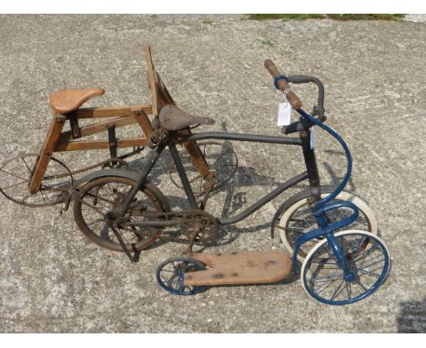 A Child's Wooden Bicycle by Hirondelle.  An early 20th Century machine with plain metal wheels, interesting chain and saddle 