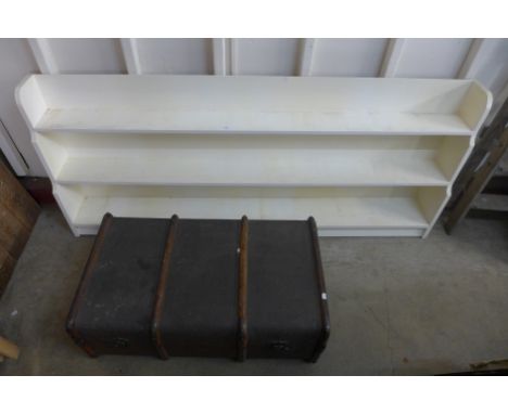 A steamer trunk and painted open bookcase
