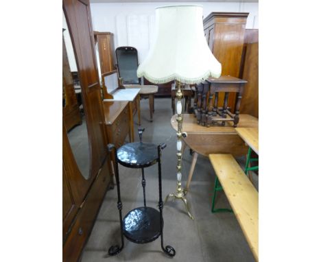 An Arts and Crafts wrought iron jardiniere stand and an onyx standard lamp