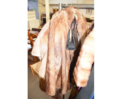 A lady's fur jacket and a leather handbag