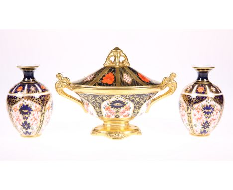 A ROYAL CROWN DERBY IMARI PATTERN TWIN HANDLED OVAL FOOTED VASE AND COVER, pattern 1128, with scroll handles and pierced fini