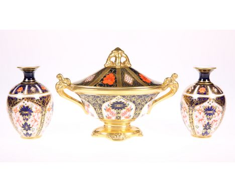 A ROYAL CROWN DERBY IMARI PATTERN TWIN HANDLED OVAL FOOTED VASE AND COVER, pattern 1128, with scroll handles and pierced fini