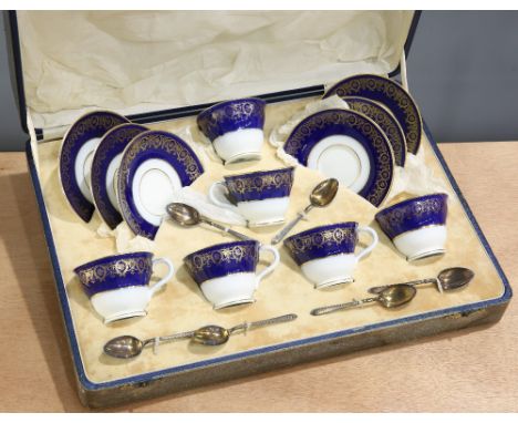 A CASED COALPORT PORCELAIN SIX PIECE TEA SERVICE, decorated with gilt swags on cobalt and white grounds, comprising six cups 