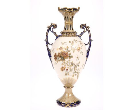 AN ERNST WAHLLIS TWIN HANDLED PORCELAIN VASE, baluster form with ornate scroll handles and pierced slender neck, raised on a 