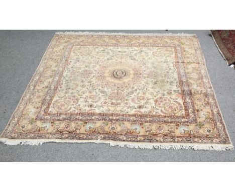 A FINE PERSIAN TABRIZ CARPET, the cream field with central roundel and scrolling foliage, enclosed within a double border. 26
