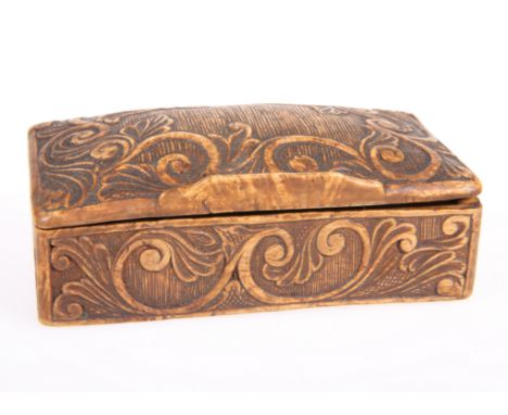 A CONTINENTAL CARVED WOOD SNUFF BOX, rectangular form with domed hinged lid and carved with scrolling foliate, the back beari