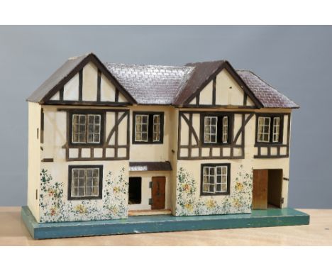 A TRI-ANG DOLLS HOUSE, model No. 77, c.1950s, in the Tudor style (a/f). Base 85.5cm wide, 31.3cm deep. House (and base) 51cm 