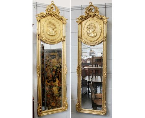 A Pair of Neo Rococo Style Gilt Framed Mirrors, with arched tops, decorated in relief with portrait medallions, 179cm by 53cm