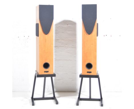 Pair of Rega speakers - walnut effect cases raised on additional stands, speaker unit 75cm high, stand 30cm high.