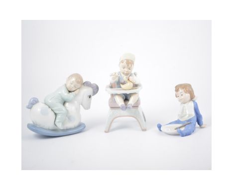 Lladro model of toddler in high chair and two Nao models of young children, (3)