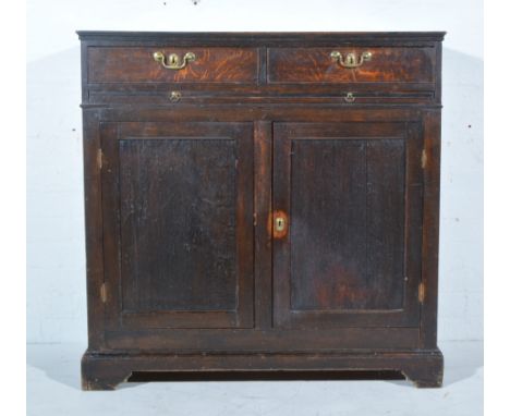 George III oak cupboard, rectangular top, two frieze drawers above a brushing slide, cupboard below, bracket feet, width 102c