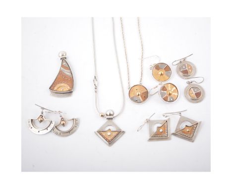 A collection of designer silver jewellery, four pairs of earrings and three similar pendants inset with ceramic discs decorat
