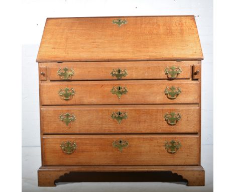 George III oak bureau, fall front, well-fitted interior with cupboard drawers and pigeon holes, above four long graduating dr