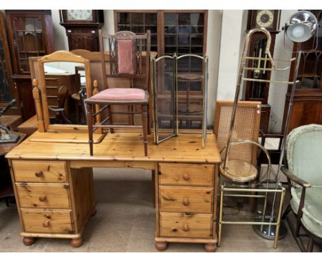 A pine dressing table together with a pine toilet mirror, an Edwardian bedroom chair, brass fire guard, brass towel rail, bra