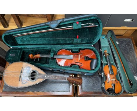 A Primavera violin with a two piece back and a lined strung back, back 35.5cm long not including button, overall 58.5cm long 