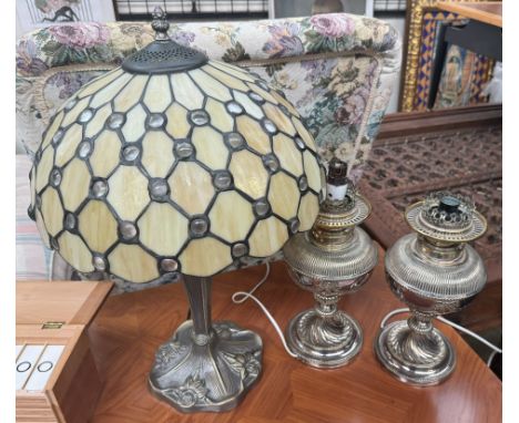A Tiffany style table lamp together with a pair of electroplated electrified oil lamps