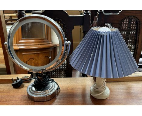 A Revlon makeup mirror together with a table lamp