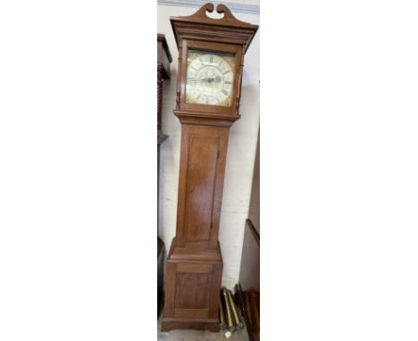 A reproduction light oak longcase clock, with a shaped cresting with a square dial and silvered dial with Roman numerals abov