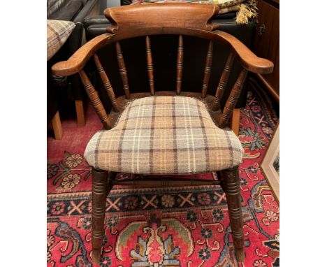 A stick back captains chair, with a pad seat on ring turned legs 