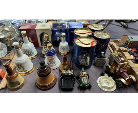 A collection of Bells Scotch Whisky commemorative decanters, boxed and loose together with ashtrays etc 