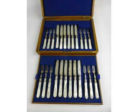 An oak cased set of twelve pairs of silver hallmarked London 1900 dessert knives and forks with mother of pearl handles and e