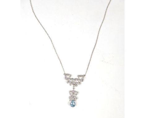 An 18ct white gold fine chainlink necklace suspending a diamond set pendant of bow shaped form above a teardrop shaped aquama