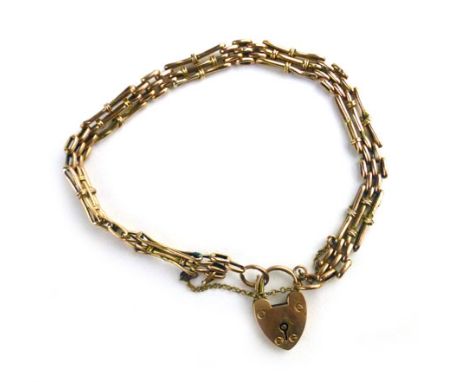 A yellow metal gate bracelet with a 9ct gold padlock. approximate weight 6.5 grams 