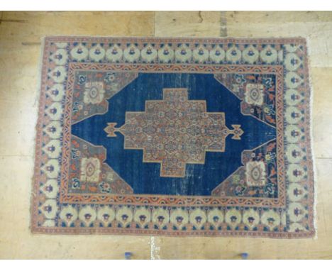 A hand woven Anatolian rug, the triple line border surrounding a blue ground field with a central medallion, 190 cm x 140 cm 
