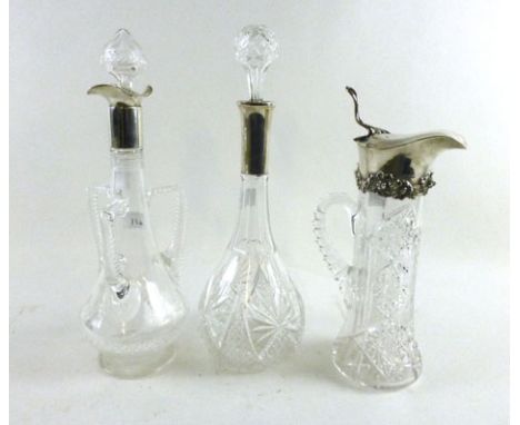 A white metal topped claret jug stamped 925 having a cut glass and handle together with a white metal glass decanter stamped 