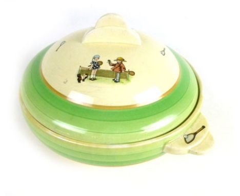 A Clarice Cliff lidded bowl with green boarders on a cream ground, decorated with children playing tennis scene d. 27cm handl