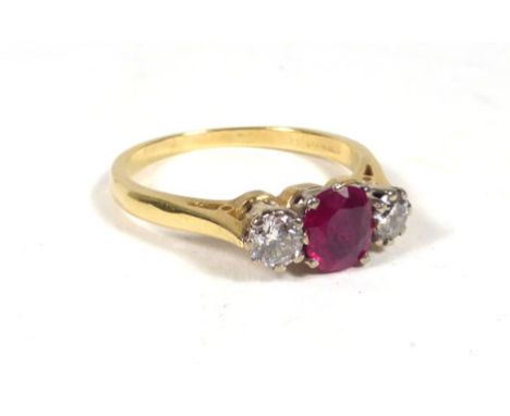 An 18ct yellow gold ring set cushion cut ruby and two brilliant cut diamonds in a raised openwork setting, ring size M. 2.8 g