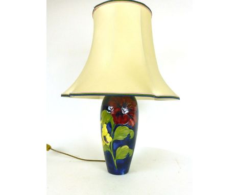 A Moorcroft vase lamp of Hibiscus pattern on a dark blue ground with impression marks to base h. 60cm (including shade)