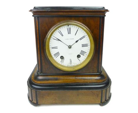 A late 19th century walnut and ebonised mantle clock, the enameled face with Roman numerals, signed by 'F. Hollinshed, Jersey