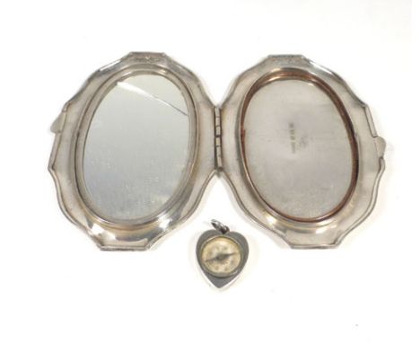 An oval silver and engine turned compact, together with a silver mounted compass of heart shaped form CONDITION REPORT: Compa