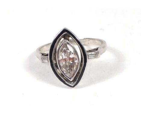 A platinum ring set marquise shaped diamond within a black enamel border, the shoulders each set a baguette cut diamond, cent