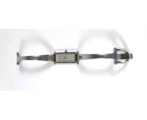 A ladies stainless steel wristwatch by Gucci, the plain rectangular dial on a bangle strap, Model No. 1500L CONDITION REPORT: