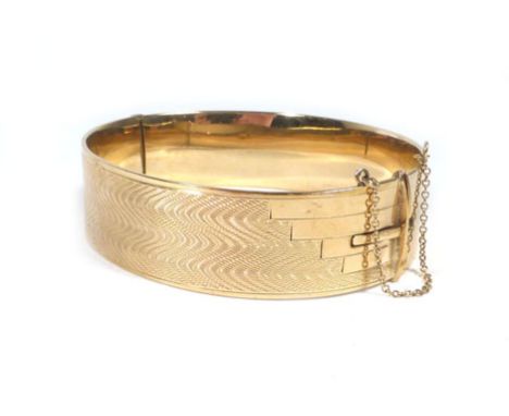 A part 9ct yellow gold bangle