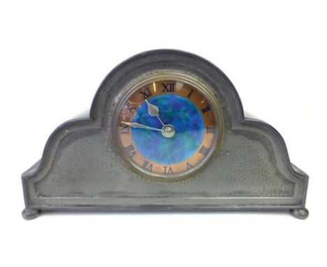 An early 20th century Liberty pewter cased mantle clock, the enameled copper face with Roman numerals and a French movement, 