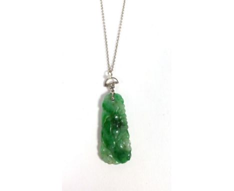 A 9ct white gold fine chainlink necklace suspending a carved jade pendant of oblong form, the suspension loop set diamonds an