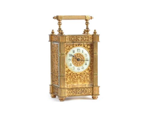 VICTORIAN BRASS CARRIAGE CLOCK WITH A CIRCULAR PORCELAIN DIAL & PIERCED BRASS SIDE PANELS.IN WORKING ORDER.